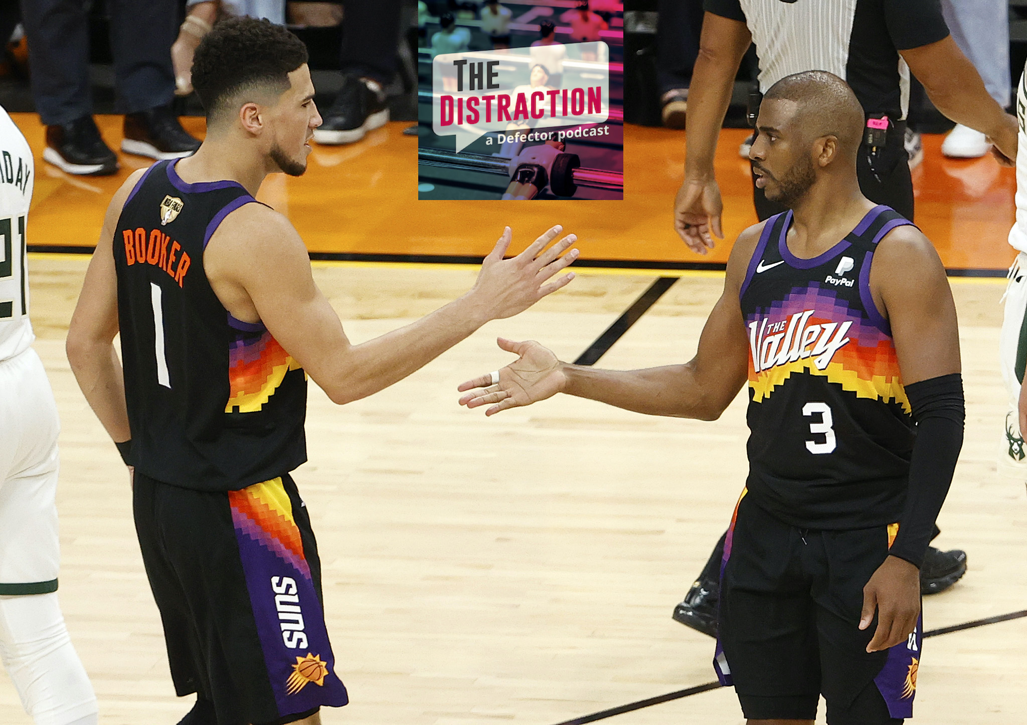 Devin Booker and Chris Paul high-five at the end of Phoenix's victory in Game 1 of the NBA Finals