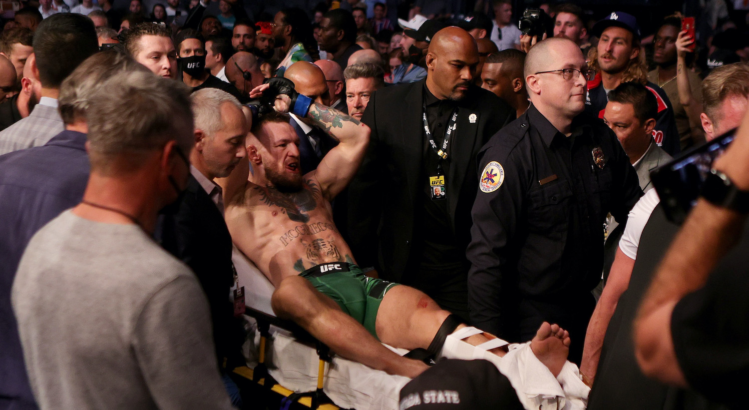 LAS VEGAS, NEVADA - JULY 10: Conor McGregor of Ireland is carried out of the arena on a stretcher after injuring his ankle in the first round of his lightweight bout against Dustin Poirier during UFC 264: Poirier v McGregor 3 at T-Mobile Arena on July 10, 2021 in Las Vegas, Nevada. (Photo by Stacy Revere/Getty Images)