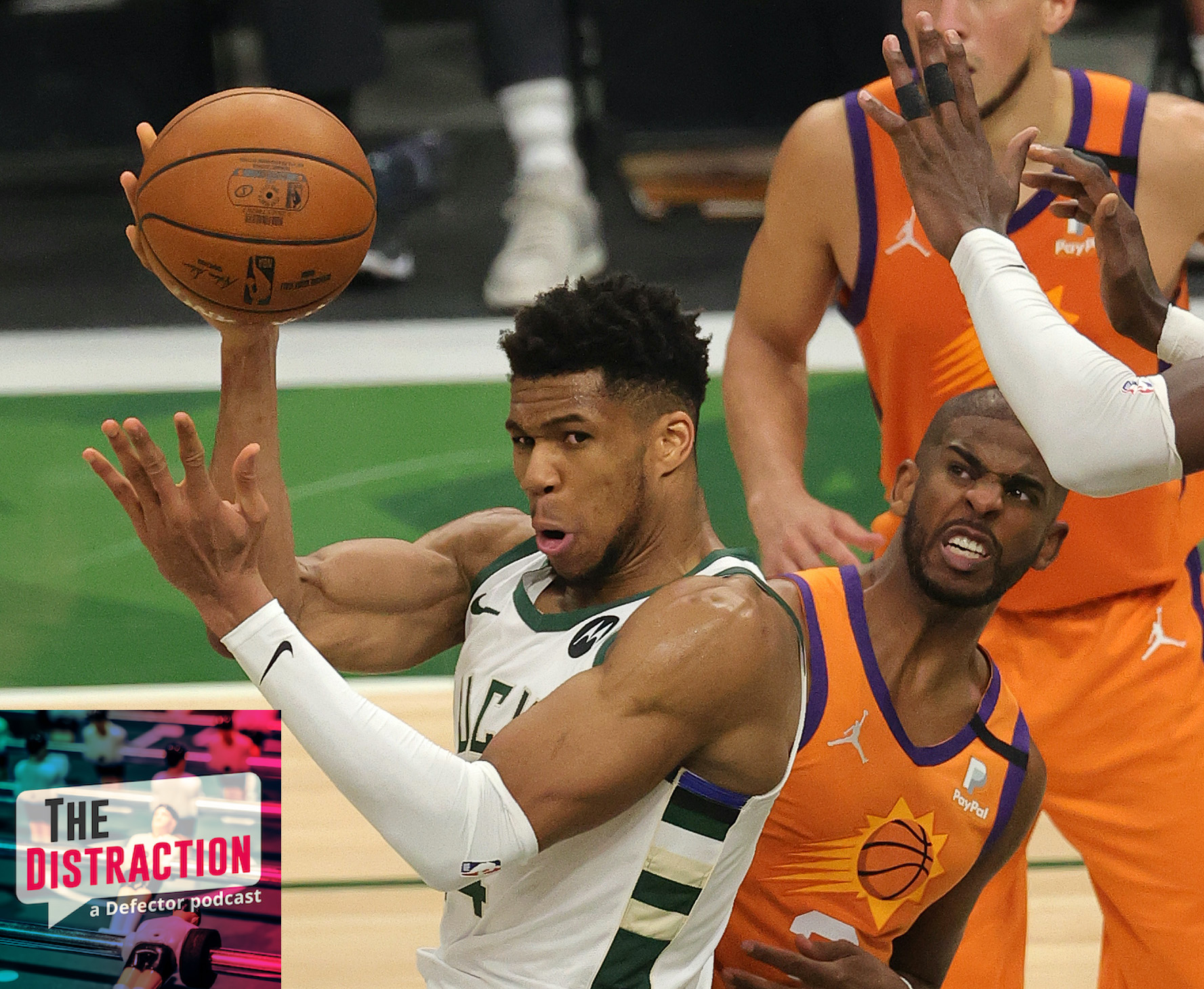 Giannis Antentokounmpo attempts a pass while being fouled by Chris Paul in Game 4 of the NBA Finals