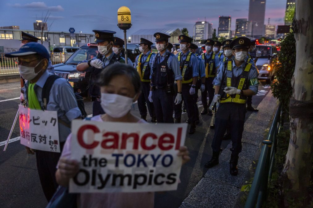 Police officers and protestors at a July protest against the Tokyo Olympics.