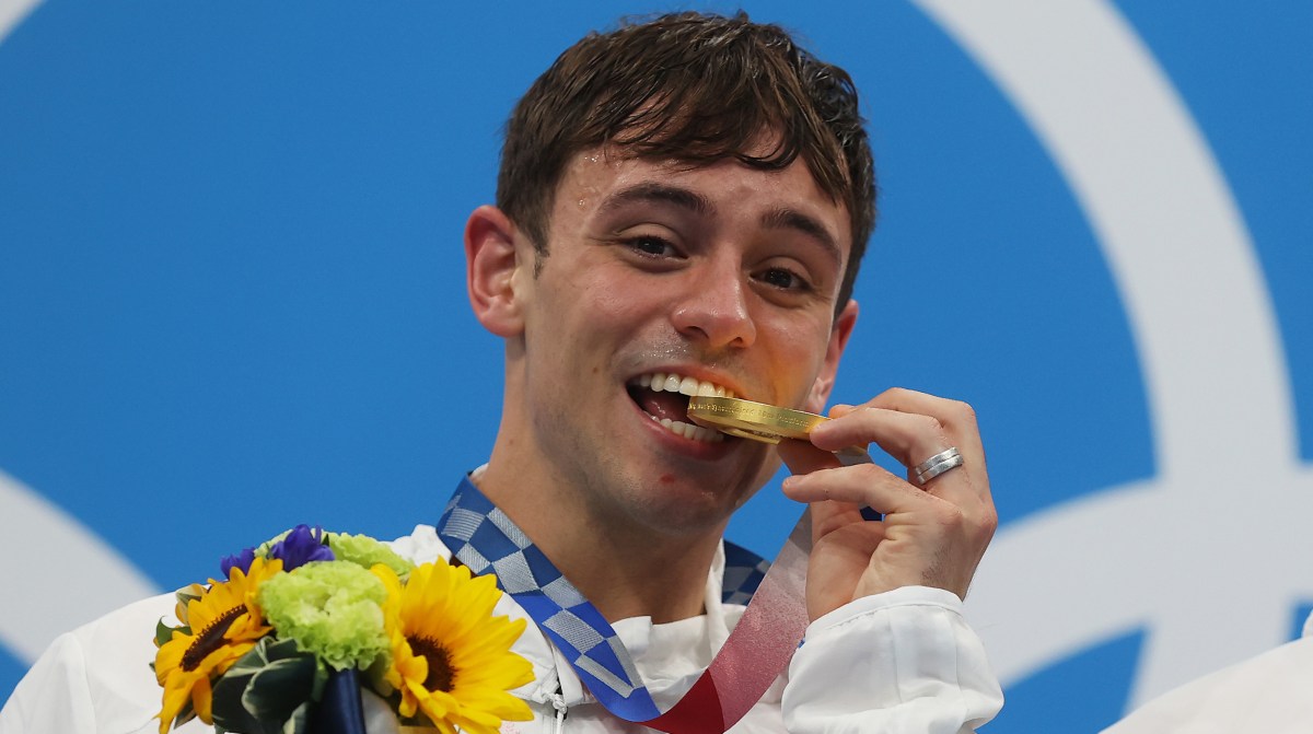 Tom Daley of Team Great Britain poses with the gold medal during the medal presentation for the Men's Synchronised 10m Platform Final on day three of the Tokyo 2020 Olympic Games at Tokyo Aquatics Centre on July 26, 2021 in Tokyo, Japan.