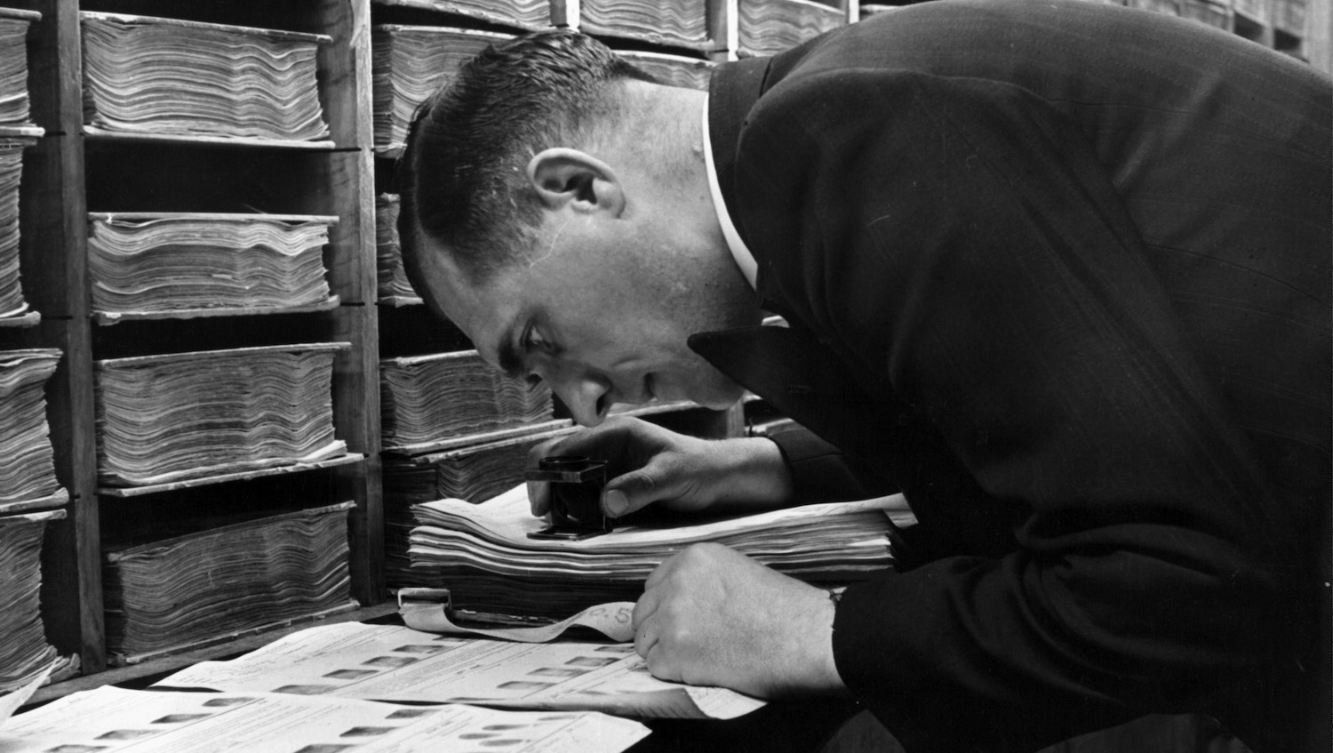 A view as a detective examines fingerprints in the Finger Department at Scotland Yard in London, England. Circa 1950. (Photo by Pictorial Parade/Archive Photos/Getty Images)