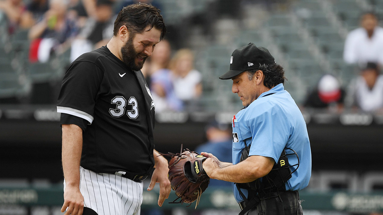 Lance Lynn's hat is checked by an umpire