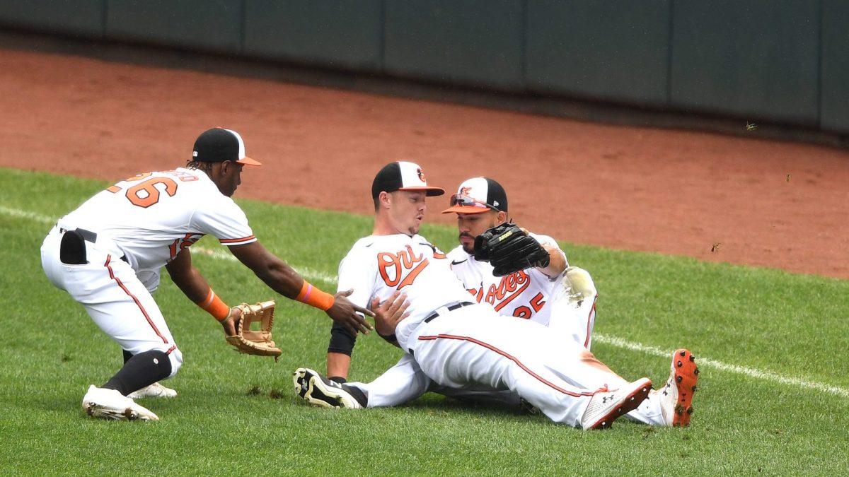 Some Baltimore Orioles crash into each other