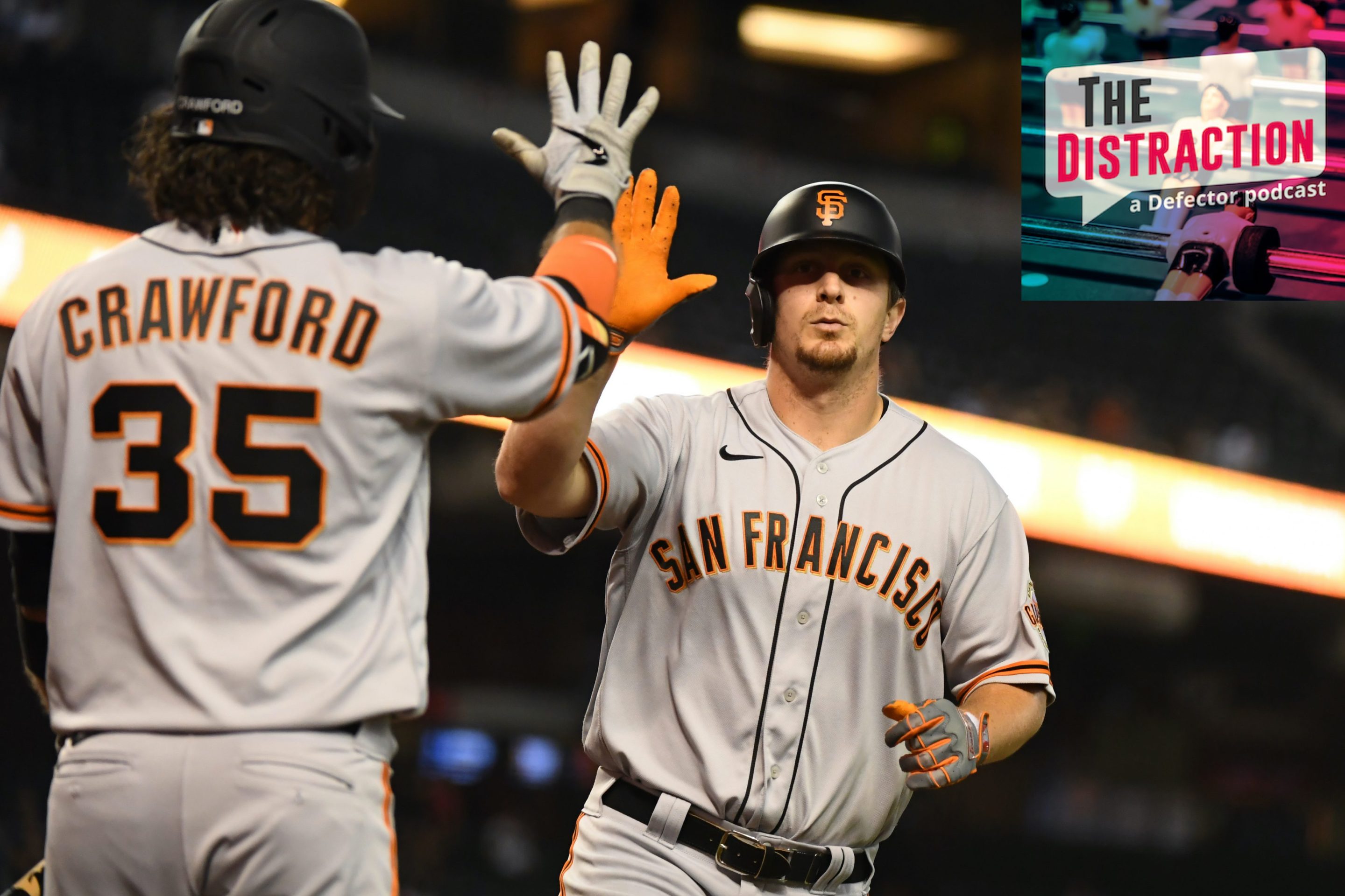 Alex Dickerson and Brandon Crawford congratulate each other at home plate, presumably for being talked about on this episode of The Distraction.