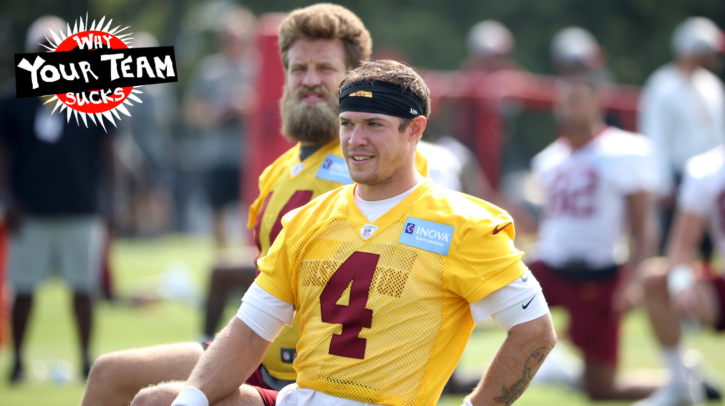 RICHMOND, VIRGINIA - JULY 29: Taylor Heinicke #4 and Ryan Fitzpatrick #14 of the Washington Football Team stretch together during training camp at the Bon Secours Washington Football Team training center park on July 29, 2021 in Richmond, Virginia. (Photo by Kevin Dietsch/Getty Images)
