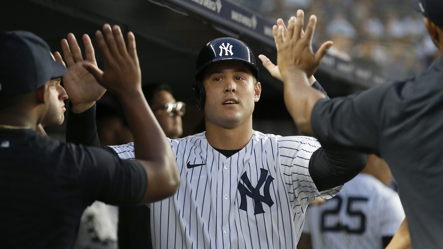 NEW YORK, NEW YORK - AUGUST 03: Anthony Rizzo #48 of the New York Yankees celebrates in the dugout with his teammates after scoring a run during the third inning against the Baltimore Orioles at Yankee Stadium on August 03, 2021 in New York City. (Photo by Jim McIsaac/Getty Images)