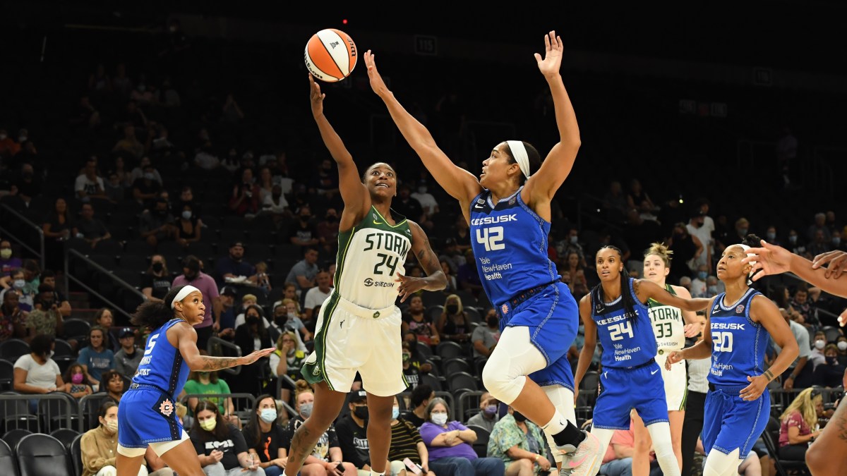 Jewell Loyd #24 of the Seattle Storm attempts a layup while being defended by Brionna Jones #42 of the Connecticut Sun during the first half of the 2021 Commissioner's Cup Championship Game at Footprint Center on August 12, 2021 in Phoenix, Arizona.