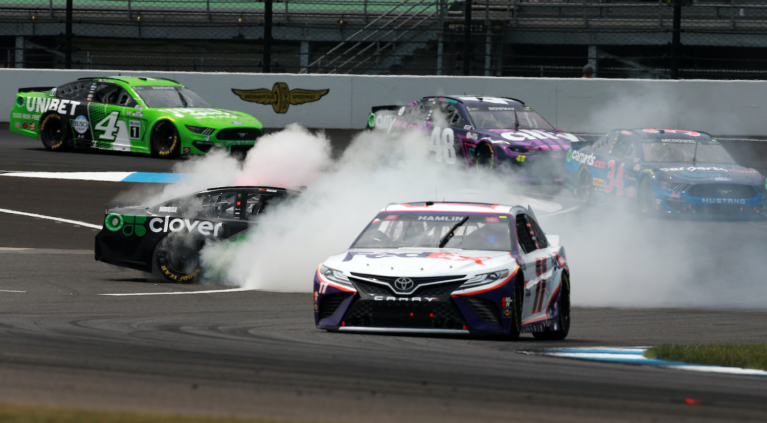 INDIANAPOLIS, INDIANA - AUGUST 15: Denny Hamlin, driver of the #11 FedEx Ground Toyota, Michael McDowell, driver of the #34 CarParts.com Ford, Alex Bowman, driver of the #48 Ally Chevrolet, and Kevin Harvick, driver of the #4 Unibet Ford, avoid Ross Chastain, driver of the #42 Clover Chevrolet, spin during the NASCAR Cup Series Verizon 200 at the Brickyard at Indianapolis Motor Speedway on August 15, 2021 in Indianapolis, Indiana. (Photo by Sean Gardner/Getty Images)