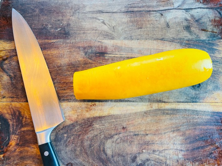 A yellow squash with the ends cut off