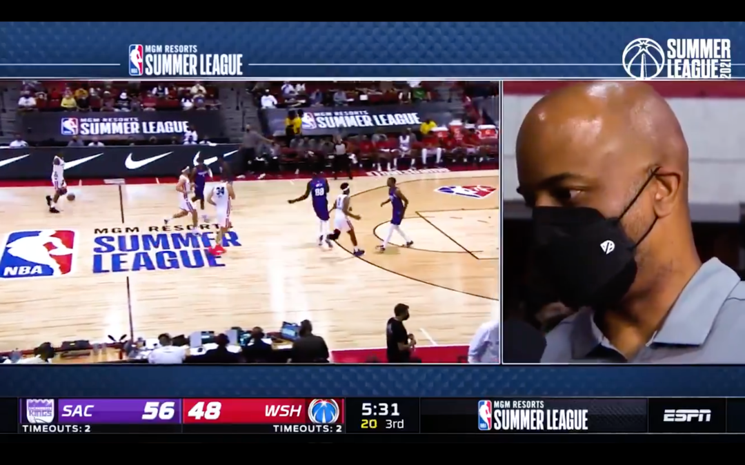 Live basketball action, and a masked man.