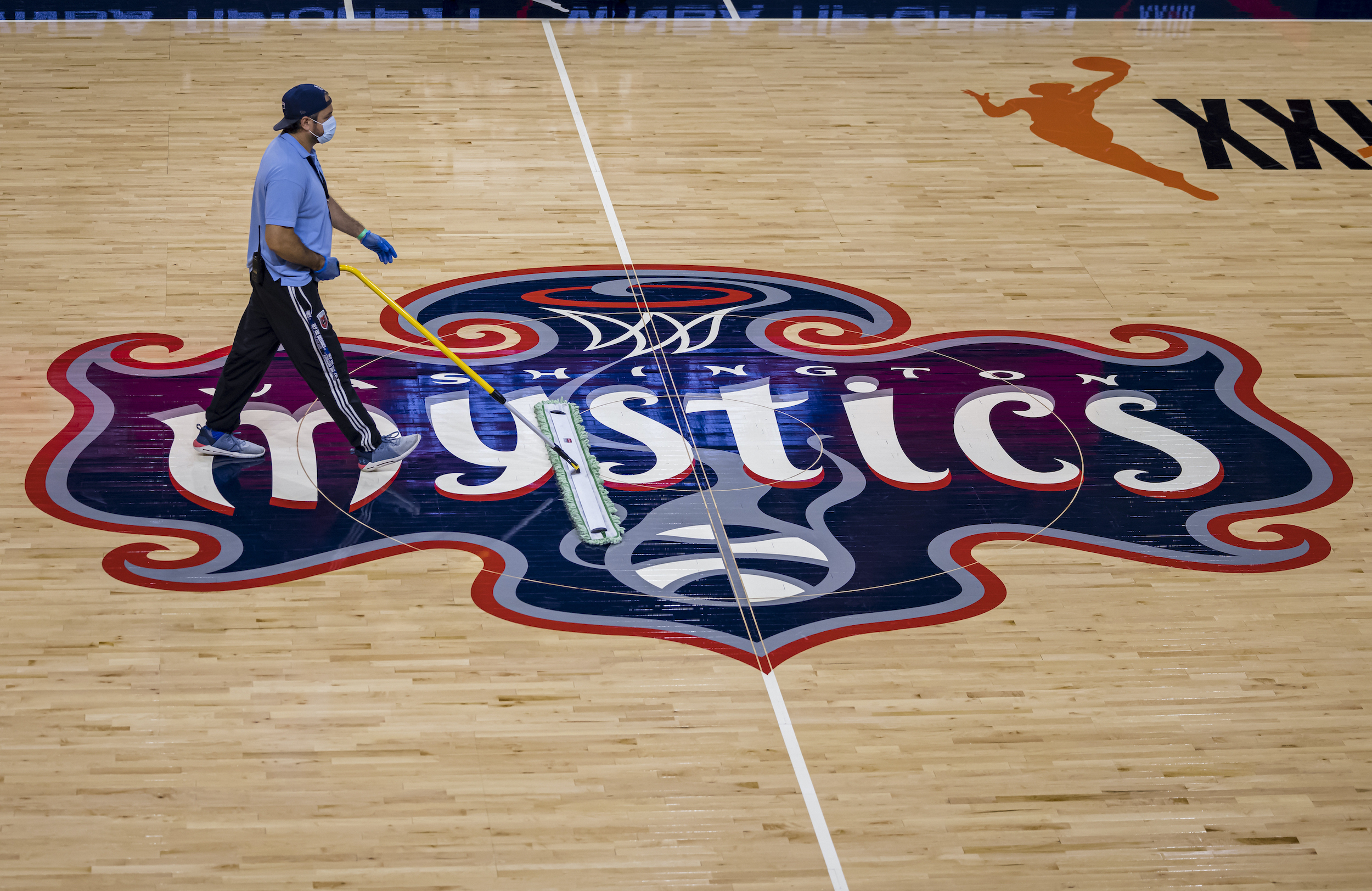 A worker sweeps the court before the second half of the game between the Washington Mystics and the Chicago Sky at Entertainment &amp; Sports Arena on May 15, 2021 in Washington, DC.