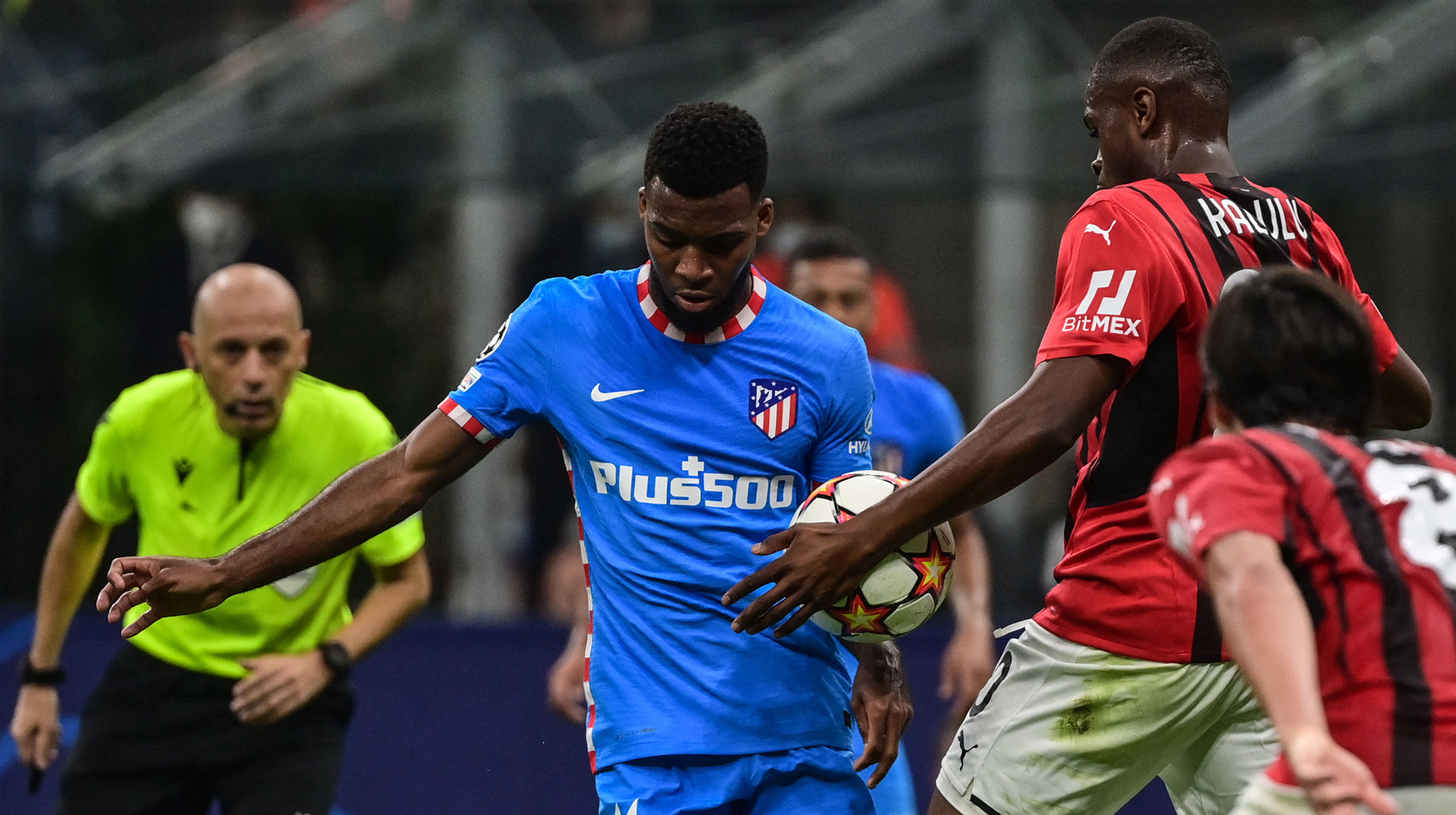AC Milan's French defender Pierre Kalulu (2ndR) touches the ball with the hand in the penalty area during the UEFA Champions League Group B football match between AC Milan and Atletico Madrid on September 28, 2021 at the San Siro stadium in Milan.