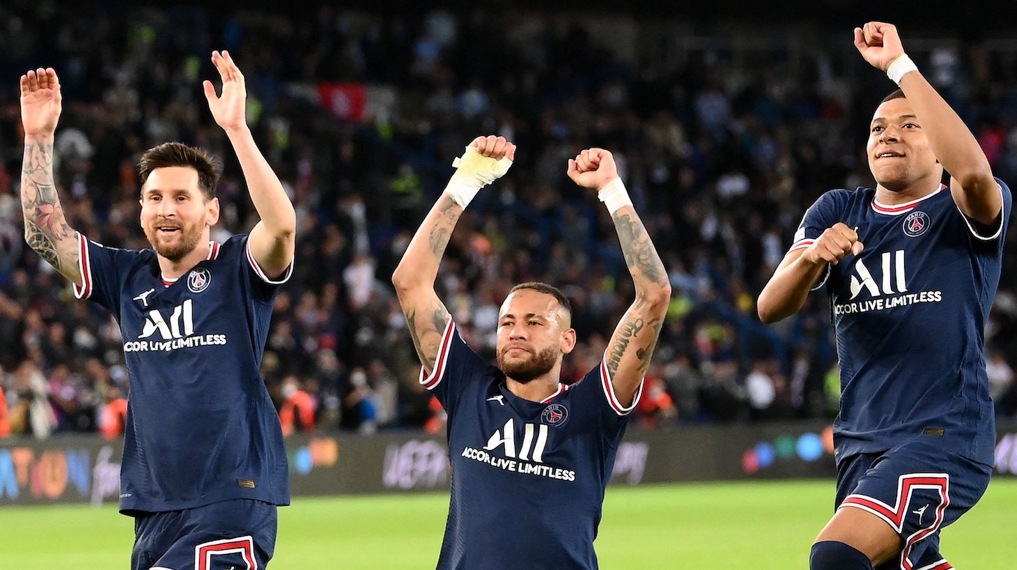 Paris Saint-Germain's Argentinian forward Lionel Messi, Paris Saint-Germain's Brazilian forward Neymar and Paris Saint-Germain's French forward Kylian Mbappe celebrate at the end of the UEFA Champions League first round group A football match between Paris Saint-Germain's (PSG) and Manchester City at The Parc des Princes stadium in Paris on September 28, 2021.