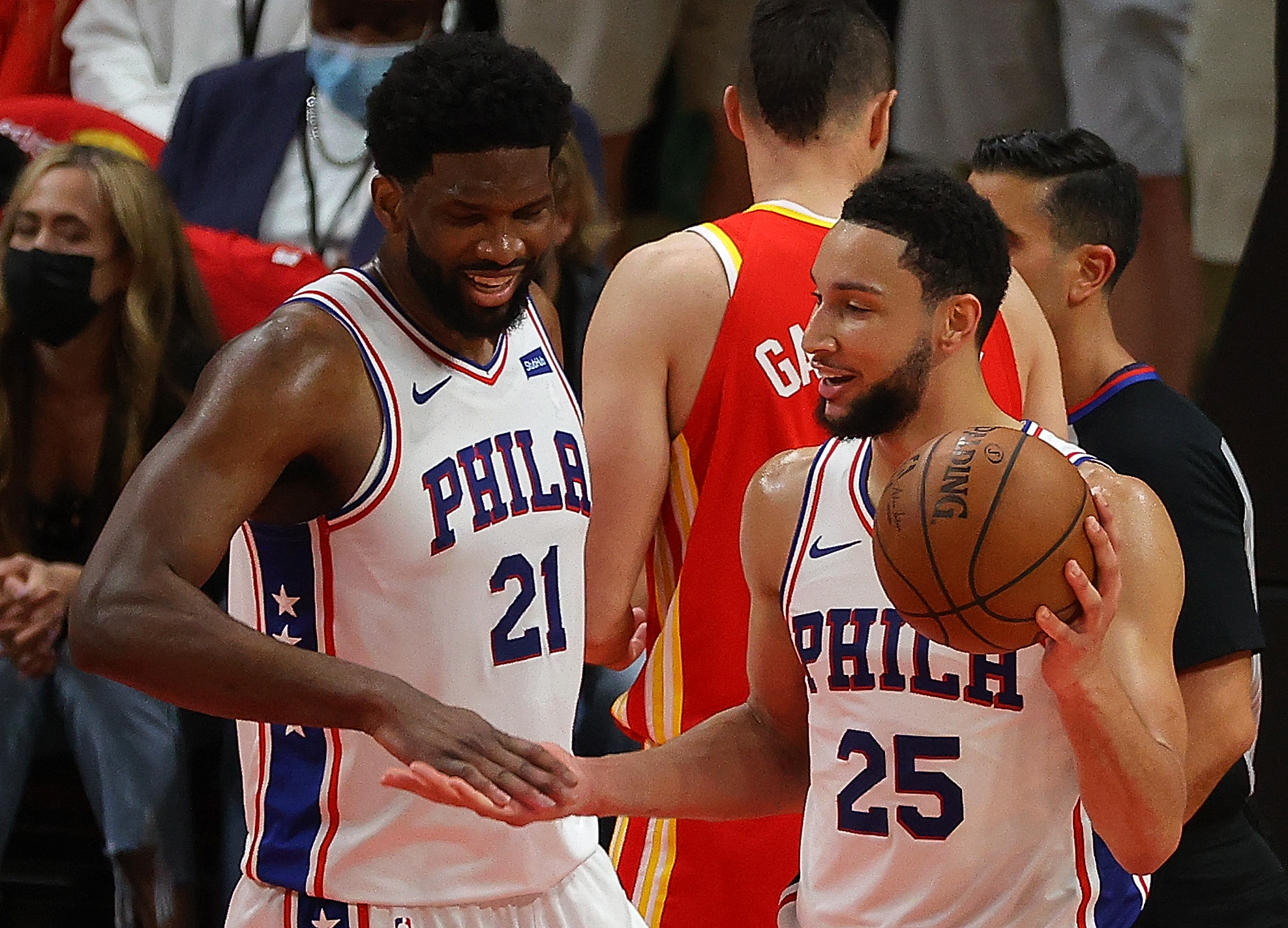 Joel Embiid high fives Ben Simmons.