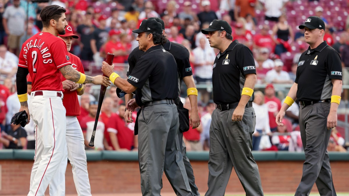 Umpires check the bat of Nick Castellanos after he destroys the St.Louis Cardinals.