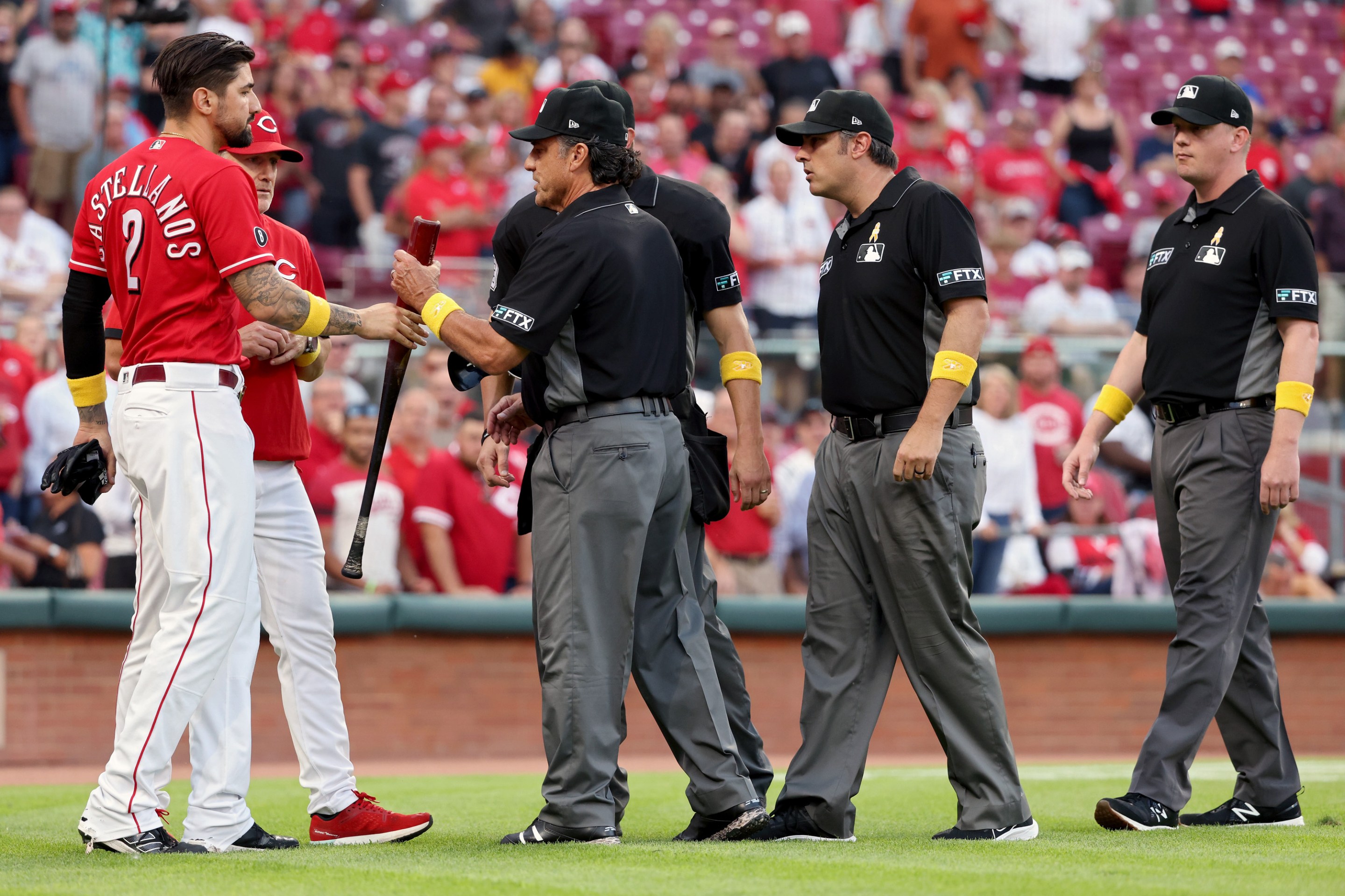 Umpires check the bat of Nick Castellanos after he destroys the St.Louis Cardinals.