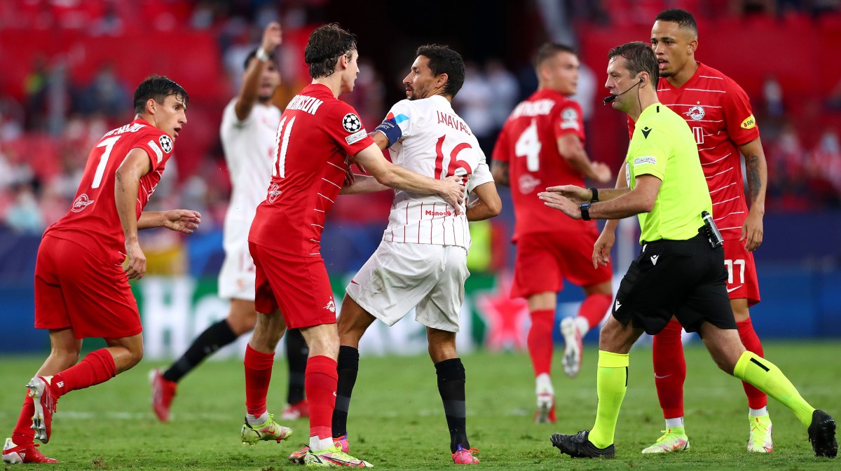 Brenden Aaronson of RB Salzburg interacts with Jesus Navas of Sevilla FC during the UEFA Champions League group G match between Sevilla FC and RB Salzburg at Estadio Ramon Sanchez Pizjuan on September 14, 2021 in Seville, Spain.