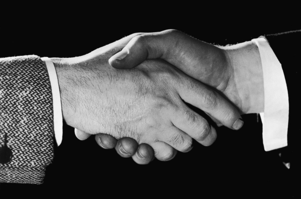 A close-up of two men shaking hands, circa 1948.
