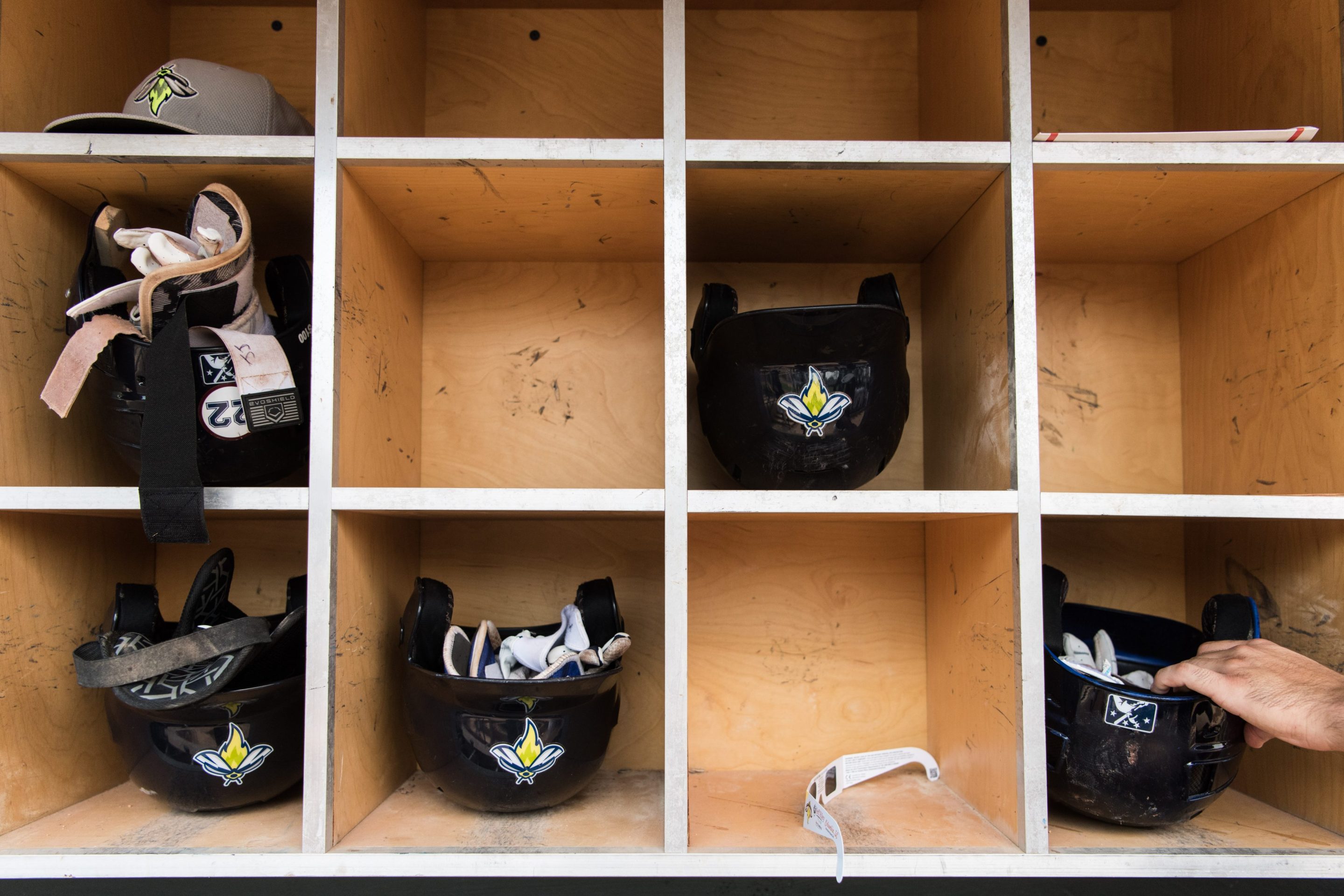 Helmets (and a pair of eclipse glasses) in the dugout of a minor league baseball team in Columbia, SC.