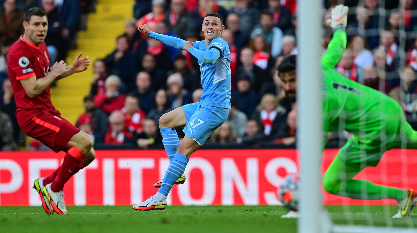 Manchester City's English midfielder Phil Foden (C) scores his team's equalisier during the English Premier League football match between Liverpool and Manchester City at Anfield in Liverpool, northwest England, on October 3, 2021.