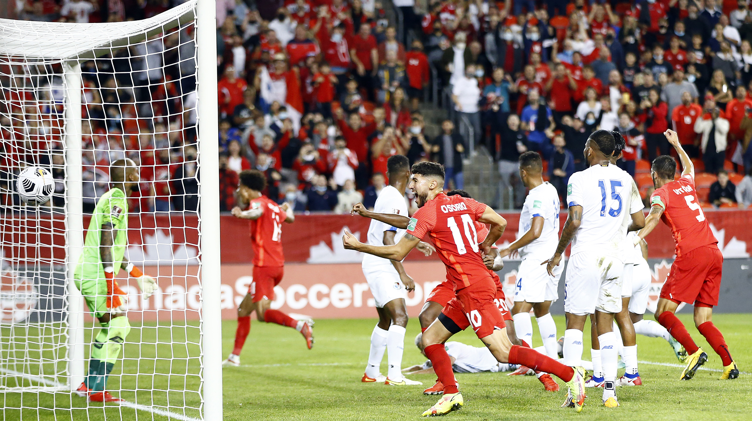 Jonathan Osorio #10 of Canada celebrates a goal by Tajon Buchanan #11 during a 2022 World Cup Qualifying match against Panama at BMO Field on October 13, 2021 in Toronto, Ontario, Canada.