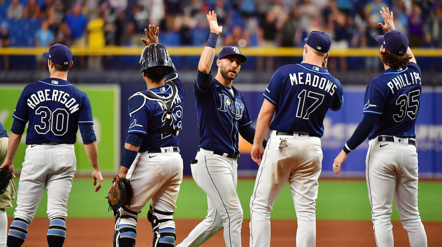 ST PETERSBURG, FLORIDA - SEPTEMBER 22: Kevin Kiermaier #39 of the Tampa Bay Rays celebrates with teammates after defeating the Toronto Blue Jays 7-1 to clinch a playoff berth at Tropicana Field on September 22, 2021 in St Petersburg, Florida. (Photo by Julio Aguilar/Getty Images)