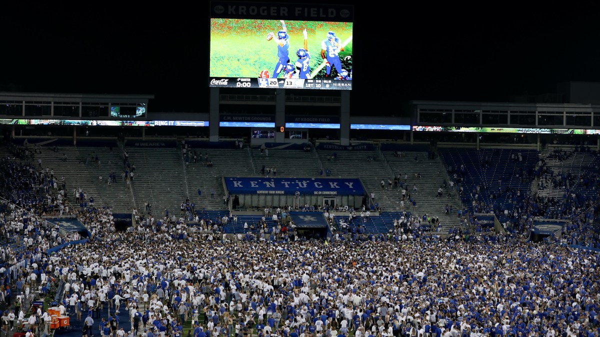 The Kentucky Wildcats fans celebrate on the field after the 20-13 win against the Florida Gators at Kroger Field on October 02, 2021 in Lexington, Kentucky.