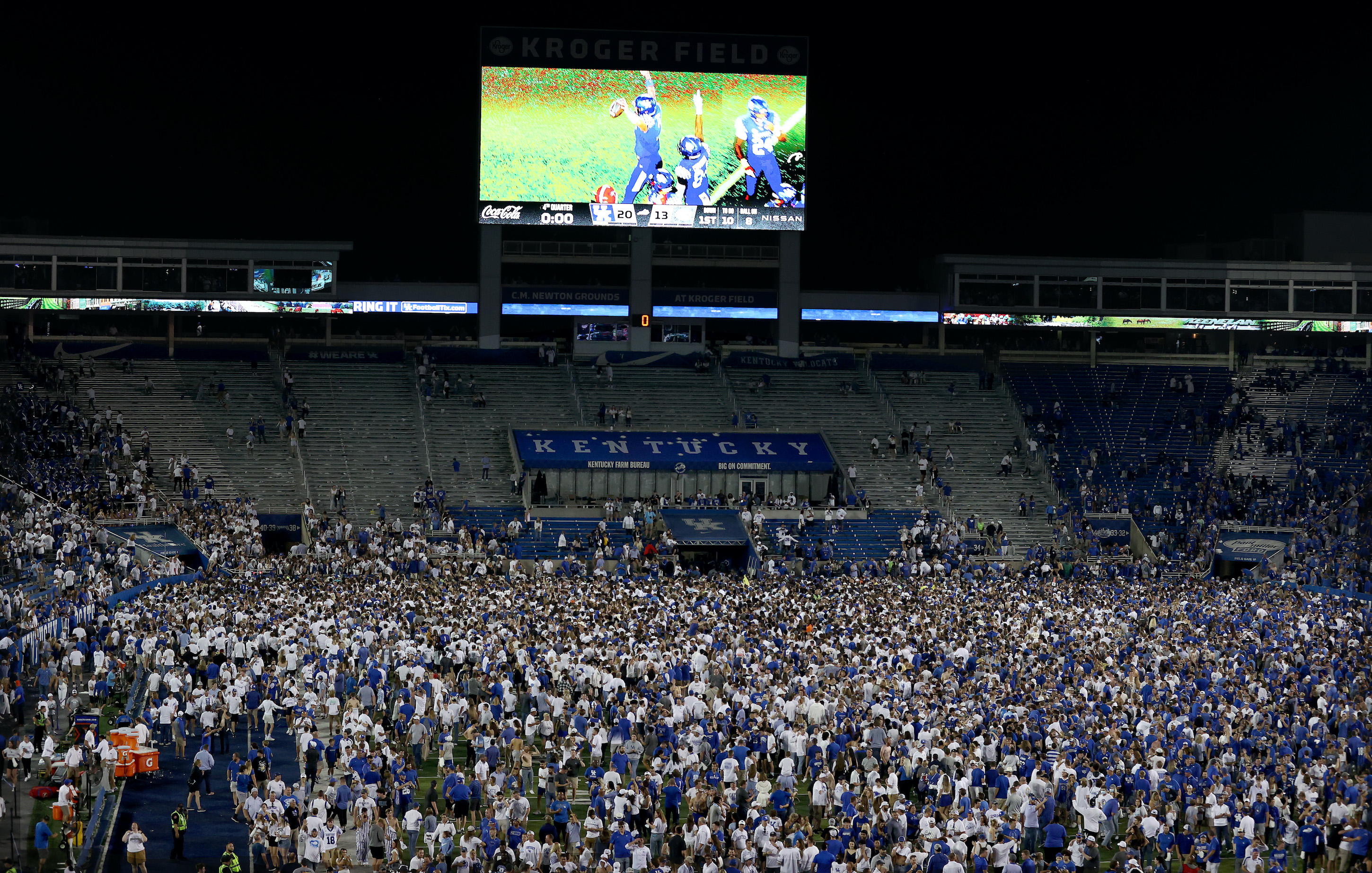The Kentucky Wildcats fans celebrate on the field after the 20-13 win against the Florida Gators at Kroger Field on October 02, 2021 in Lexington, Kentucky.
