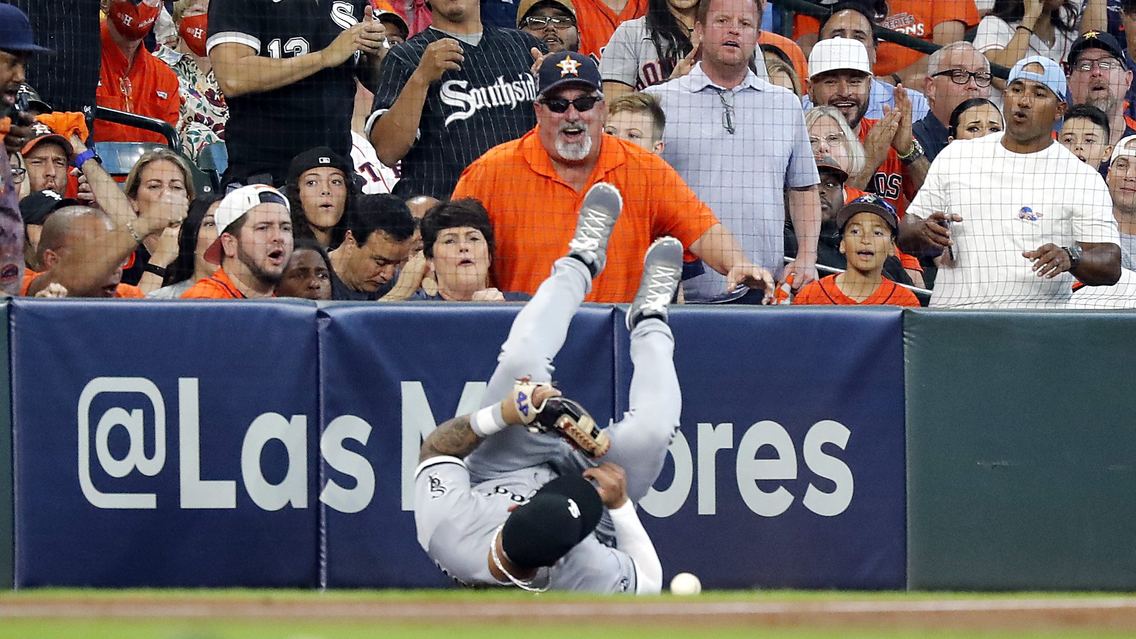 Yoan Moncada of the Chicago White Sox sprawled on the ground in front of jeering Houston Astros fans
