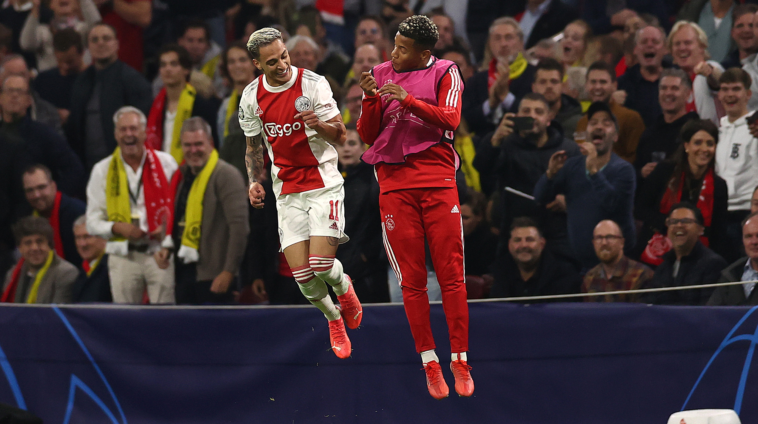 Antony of Ajax celebrates with David Neres after scoring their side's third goal during the UEFA Champions League group C match between AFC Ajax and Borussia Dortmund at Amsterdam Arena on October 19, 2021 in Amsterdam, Netherlands.