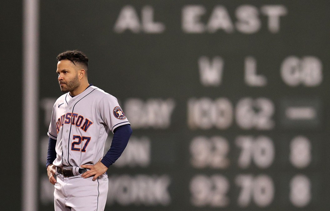 Jose Altuve stands without his hat in the field, looking unhappy