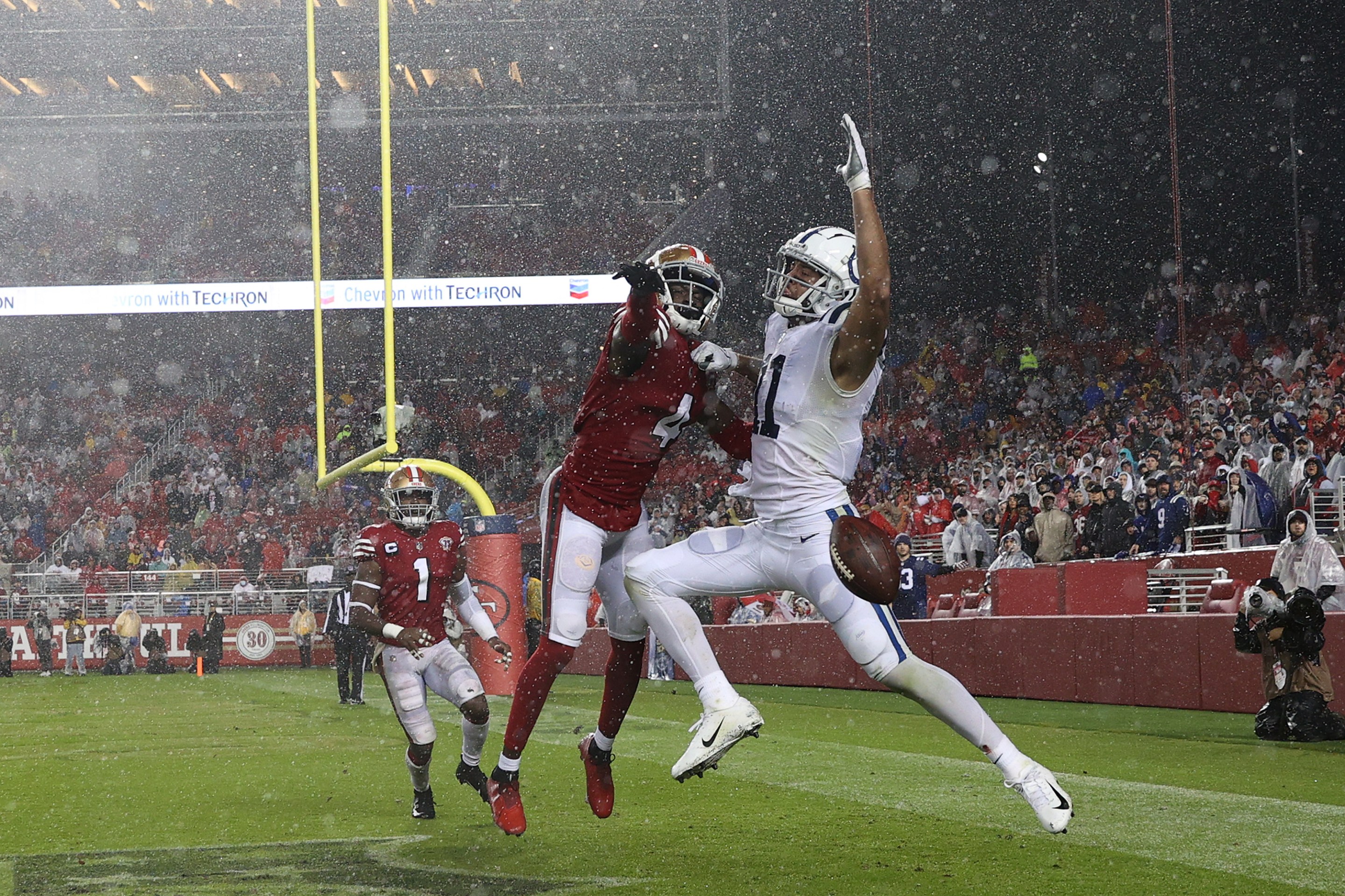 Colts receiver Michael Pittman Jr. and 49ers defensive back Emmanuel Moseley compete for a pass in the rain on Sunday Night Football.