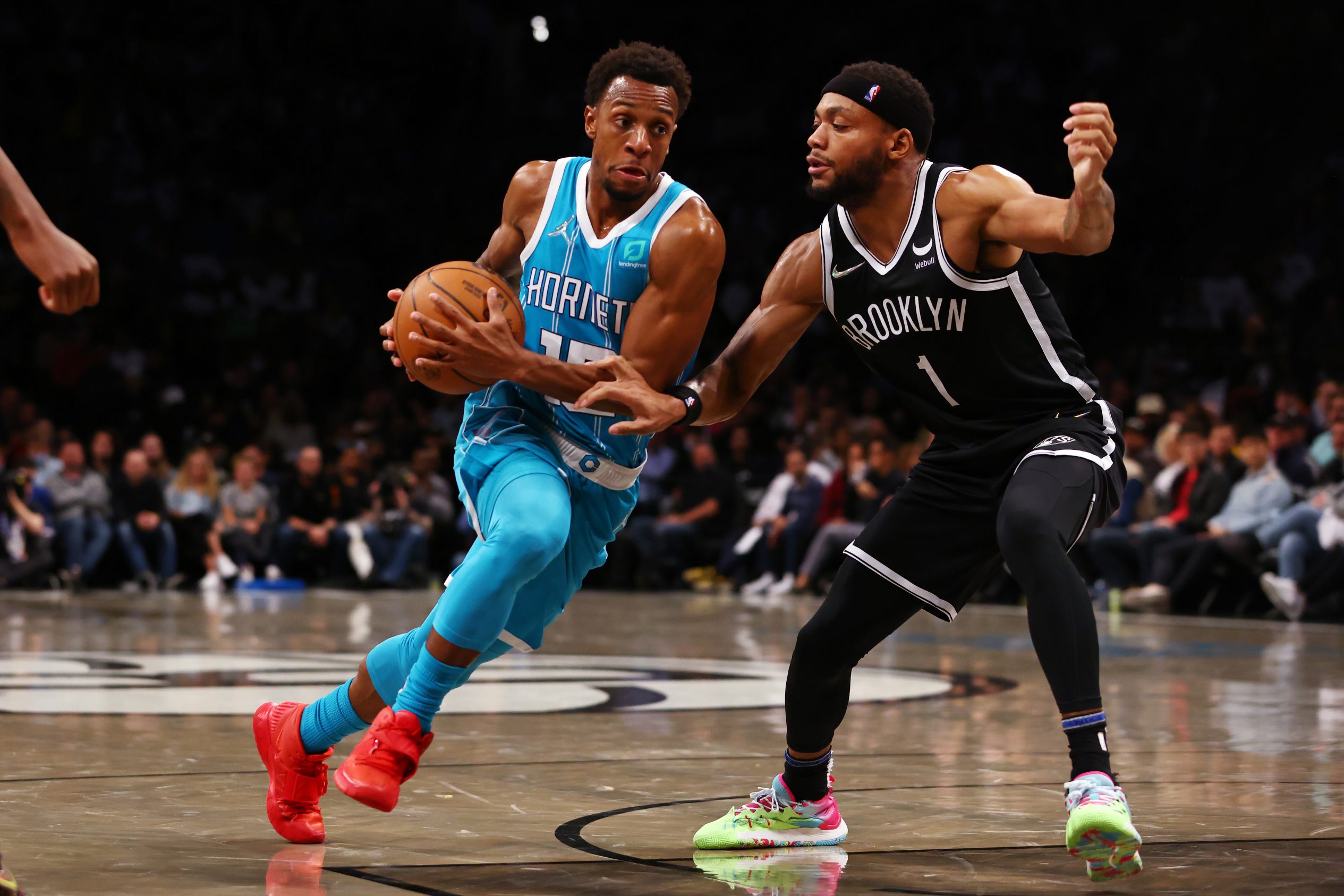 Ish Smith #10 of the Charlotte Hornets in action against Bruce Brown #1 of the Brooklyn Nets during a game at Barclays Center on October 24, 2021 in New York City.