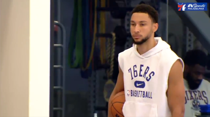 Ben Simmons stands sullenly at Sixers practice.