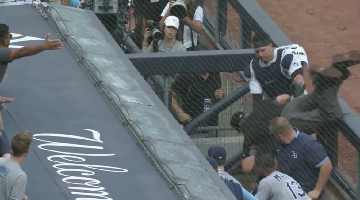 A dugout scene, overhead from 3/4 perspective. An umpire is falling over the dugout railing and into the dugout