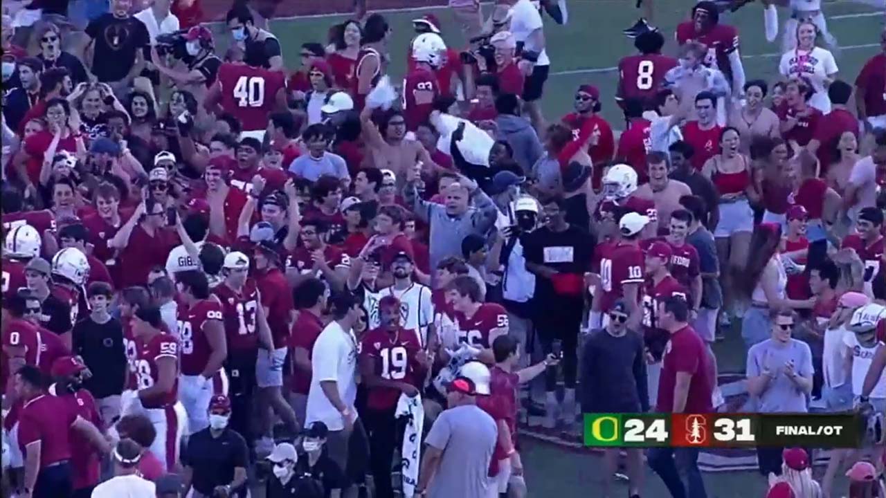 Fans mob the field after Stanford upset Oregon. the quality of the still is not very good.