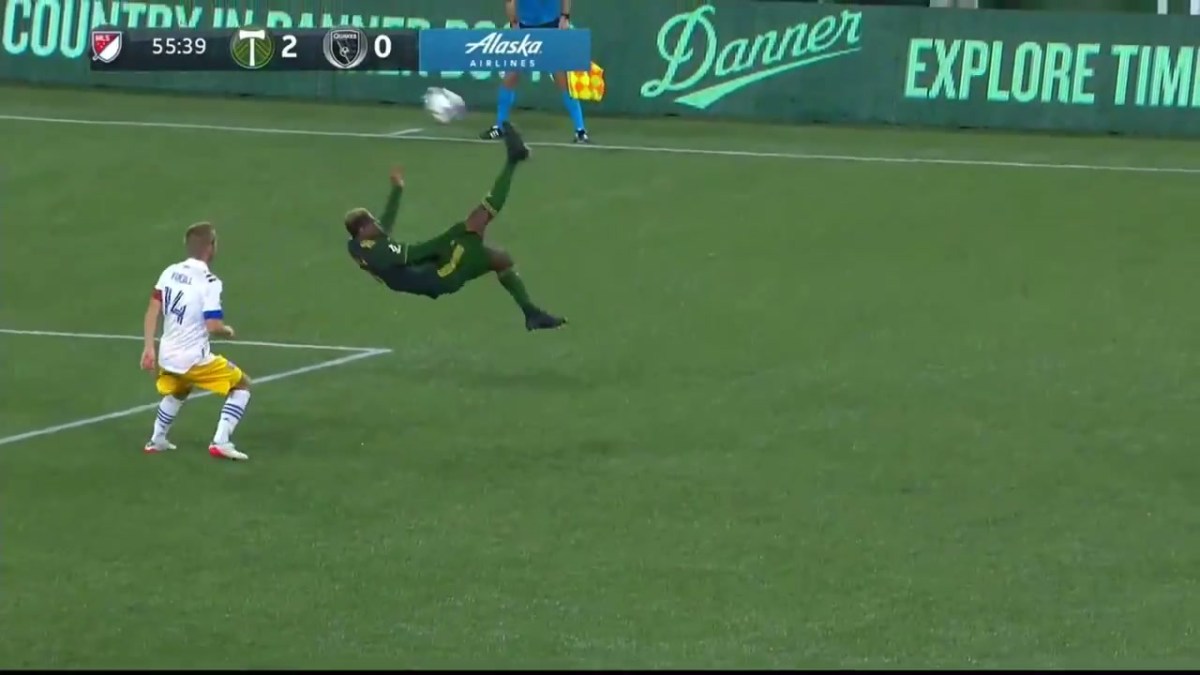 A Portland Timbers player hits a bicycle/overhead kick near the 18-yard box