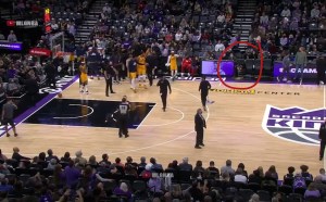 A Kings fan vomits on the court. A Jazz player looks at him. He’s circled with a red circle.