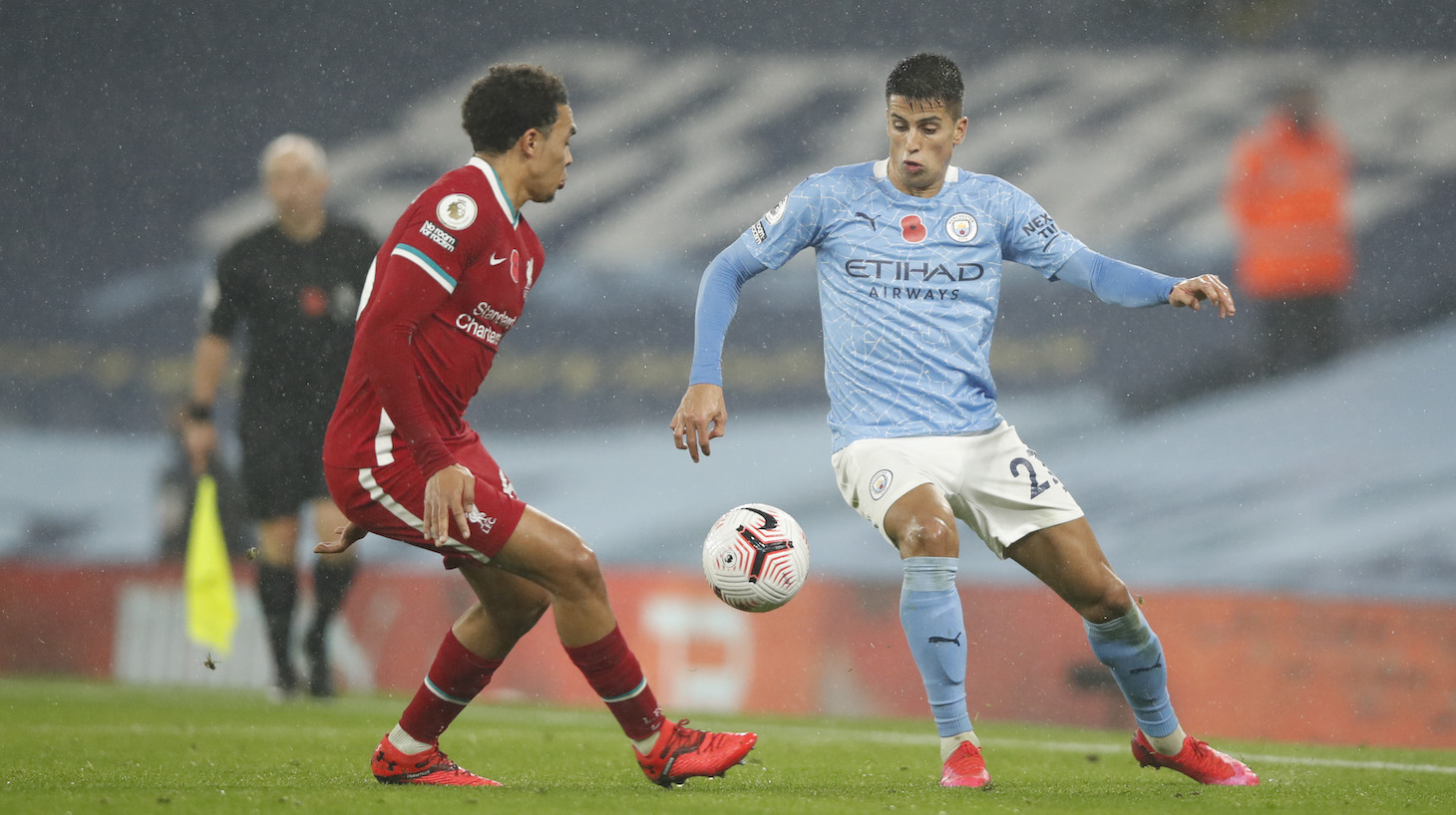 Joao Cancelo of Manchester City is challenged by Trent Alexander-Arnold of Liverpool during the Premier League match between Manchester City and Liverpool at Etihad Stadium on November 08, 2020 in Manchester, England.