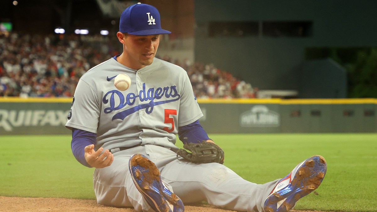 Corey Seager, seen here sitting on his butt tossing a baseball up in the air back when he was with the Dodgers, and before he joined the Rangers.