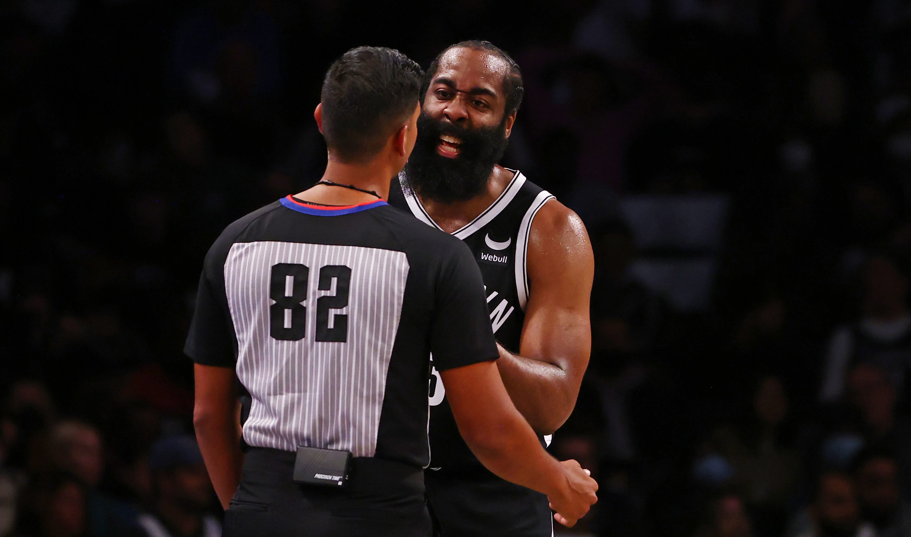 James Harden argues with a referee.