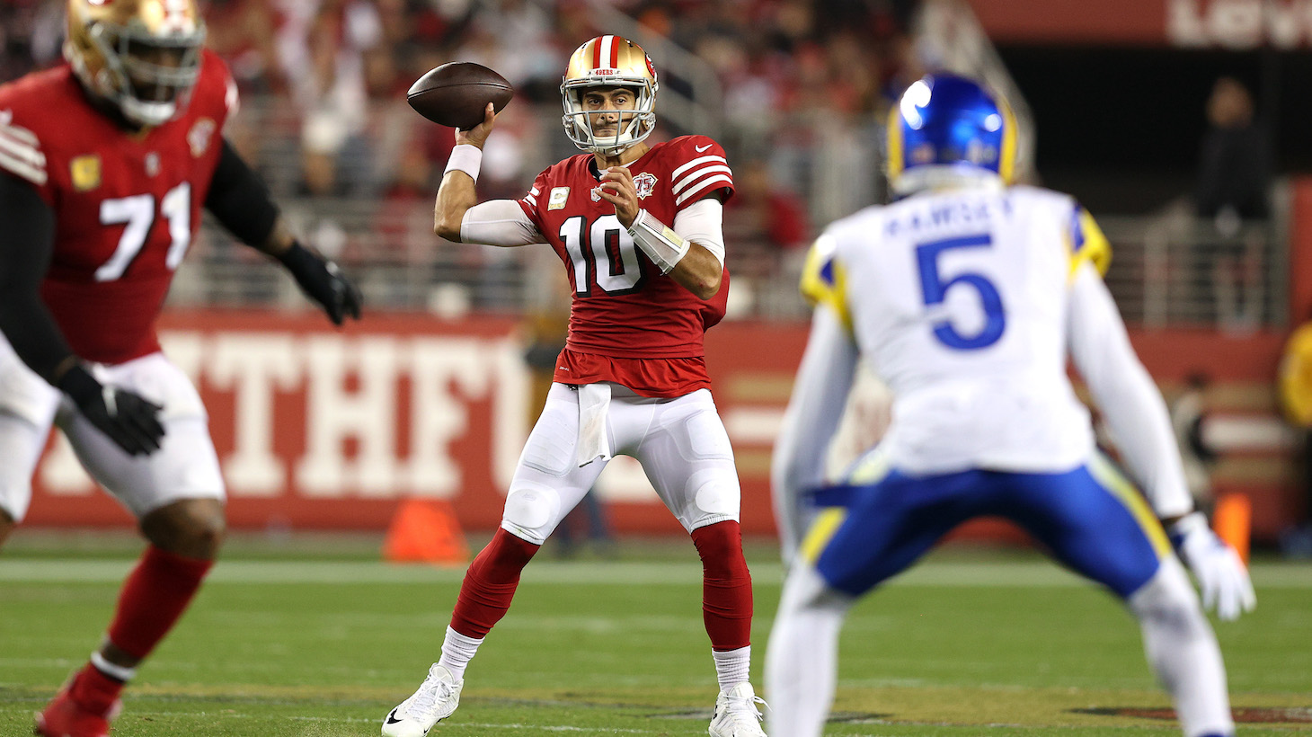 SANTA CLARA, CALIFORNIA - NOVEMBER 15: Jimmy Garoppolo #10 of the San Francisco 49ers looks for an open teammate during the third quarter in the game against the Los Angeles Rams at Levi's Stadium on November 15, 2021 in Santa Clara, California. (Photo by Ezra Shaw/Getty Images)
