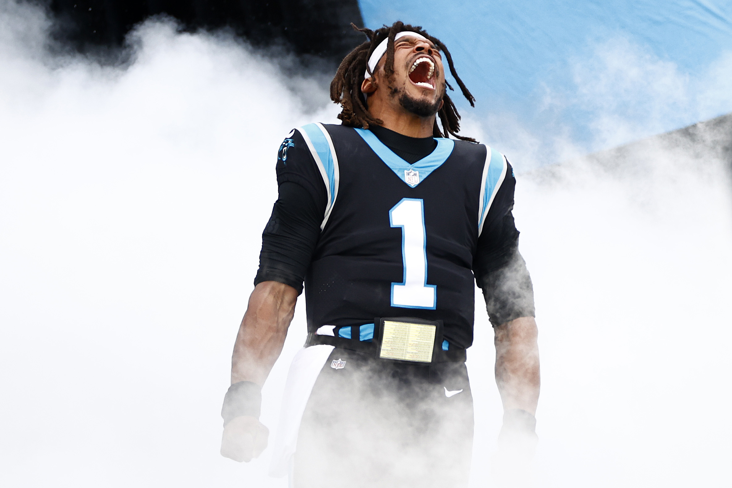 Cam Newton roaring amid smoke machine effects while being introduced before the Panthers' Week 11 game.