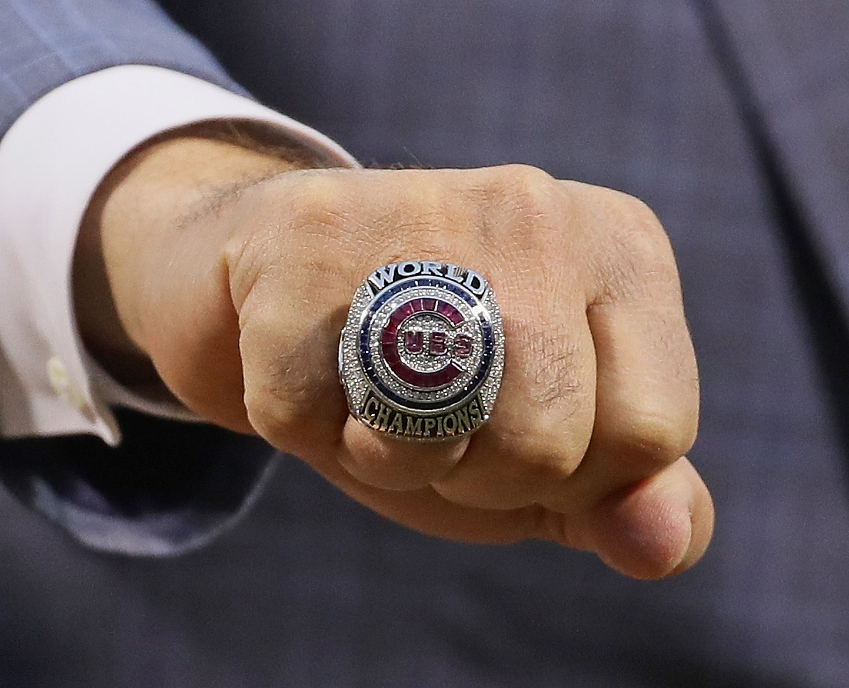 General manager Jed Hoyer of the Chicago Cubs show off the World Series Championship ring before a game against the Los Angeles Dodgers at Wrigley Field on April 12, 2017 in Chicago, Illinois.