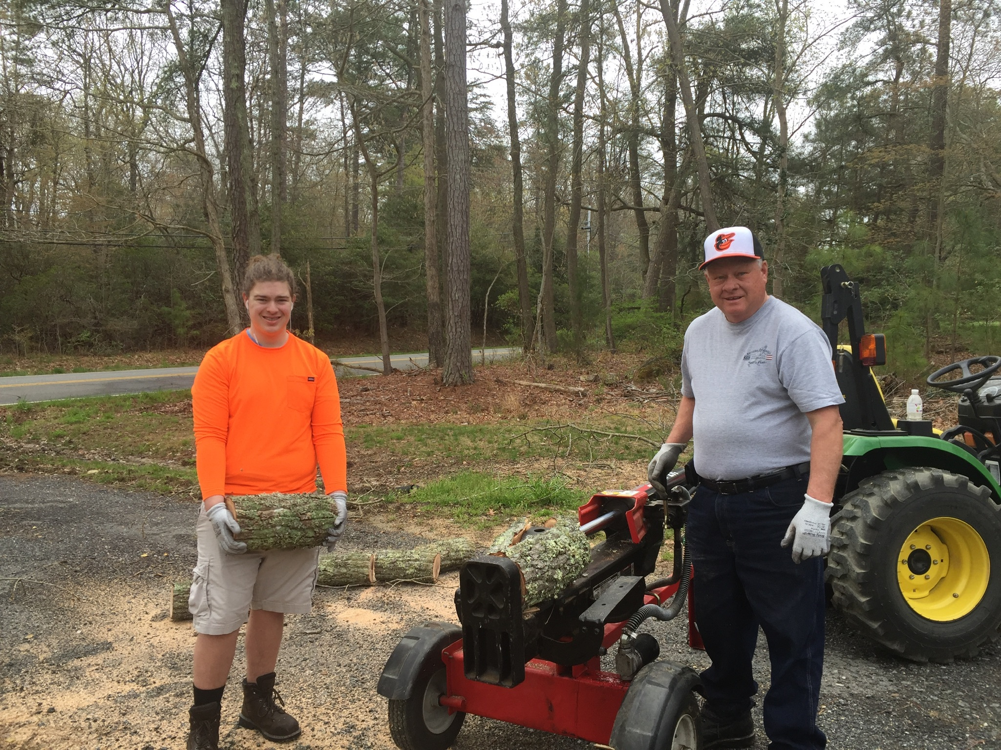 Peyton Ham, a 16-year-old from Leonardtown, Md, stands next to his grandfather, Keith Raley, while doing tree clearing work. Two days after this photo was taken Ham was shot and killed by a Maryland State Police trooper.