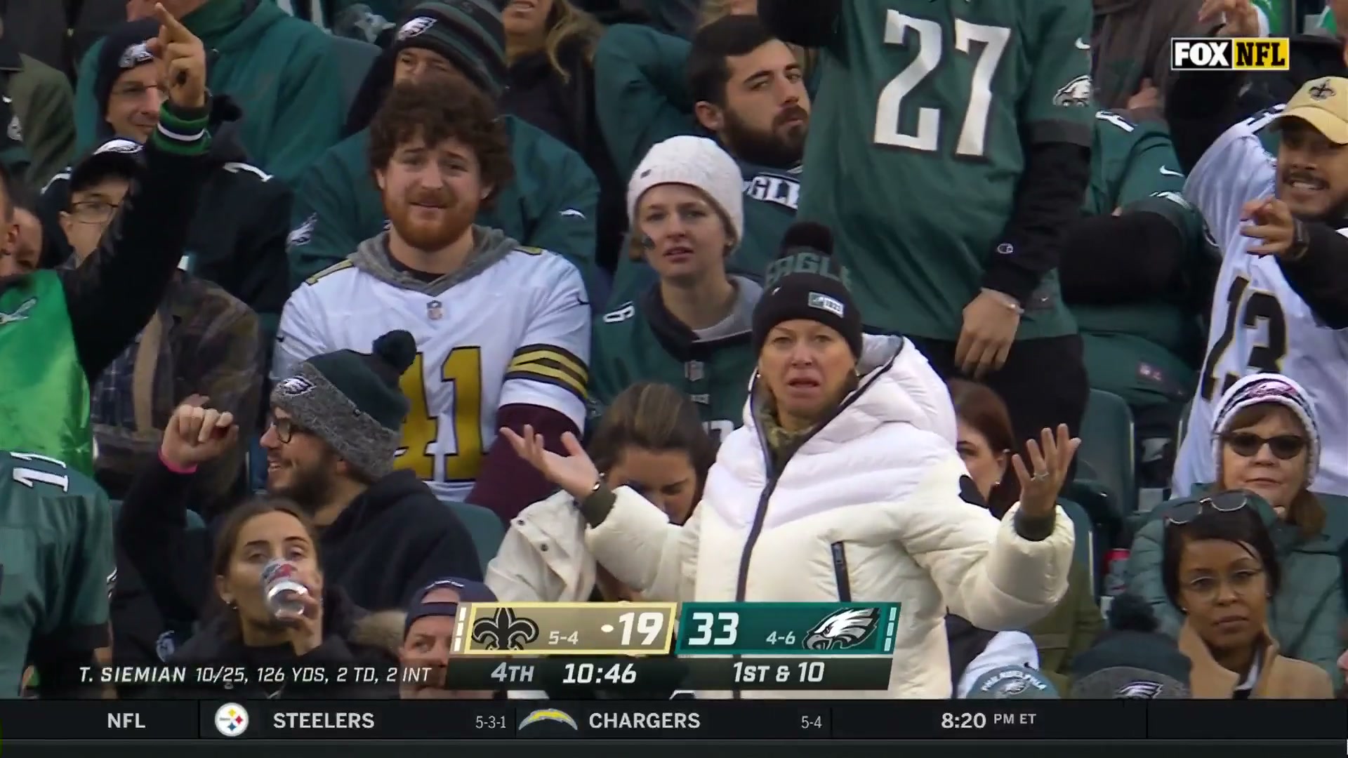 An Eagles fan puts her hands up in a "WHAT" motion