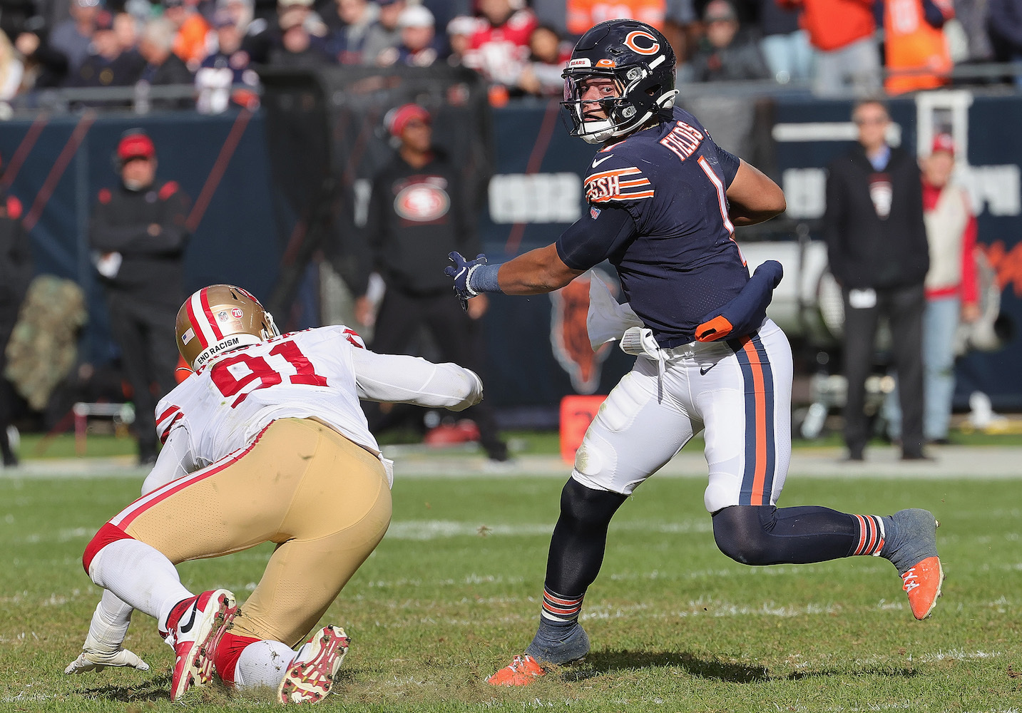 CHICAGO, ILLINOIS - OCTOBER 31: Justin Fields #1 of the Chicago Bears breaks a tackle by Arik Armstead #91 of the San Francisco 49ers at the start of a touchdown run at Soldier Field on October 31, 2021 in Chicago, Illinois. The 49ers defeated the Bears 33-22. (Photo by Jonathan Daniel/Getty Images)