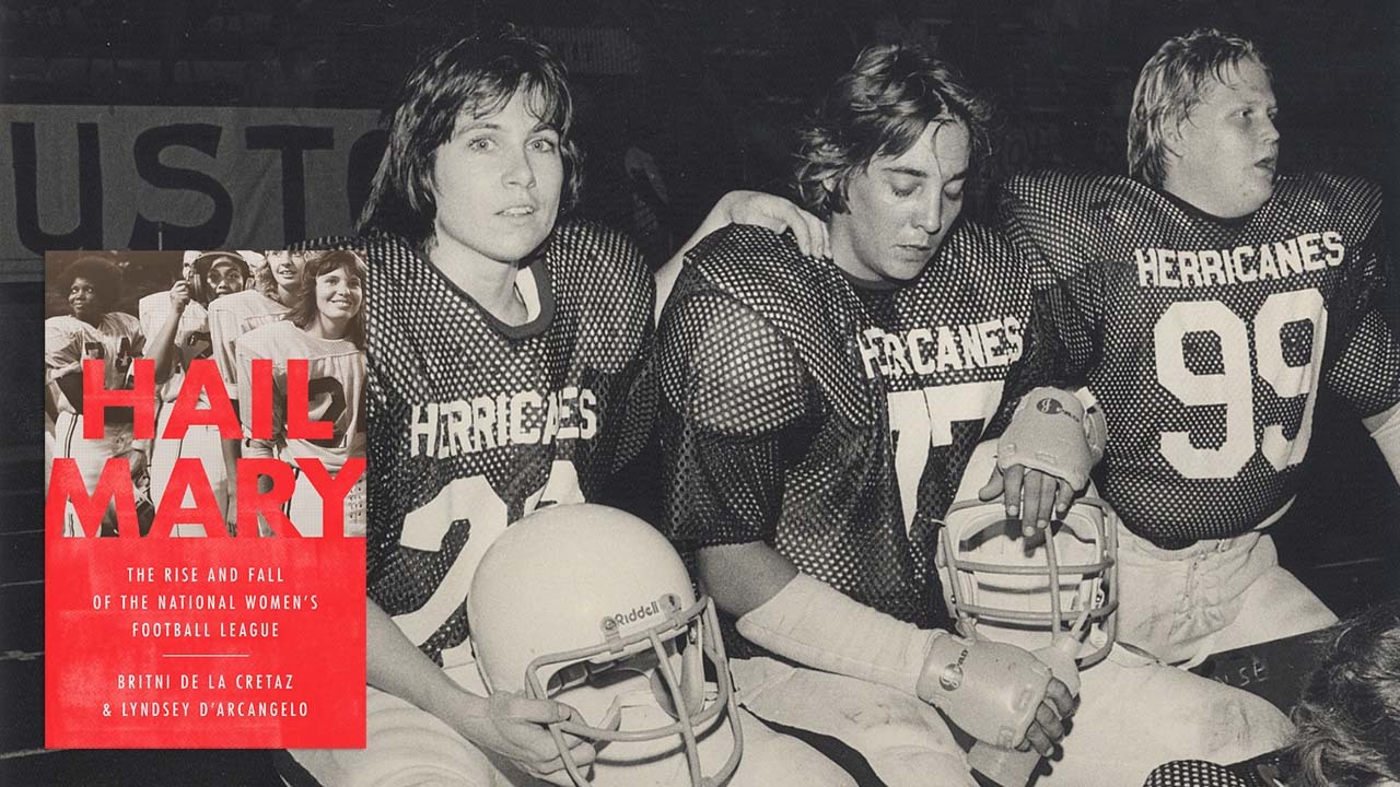 A photo of three NWFL players in their Houston Herricanes uniforms. They are all sitting on the bench, with their helmets off.