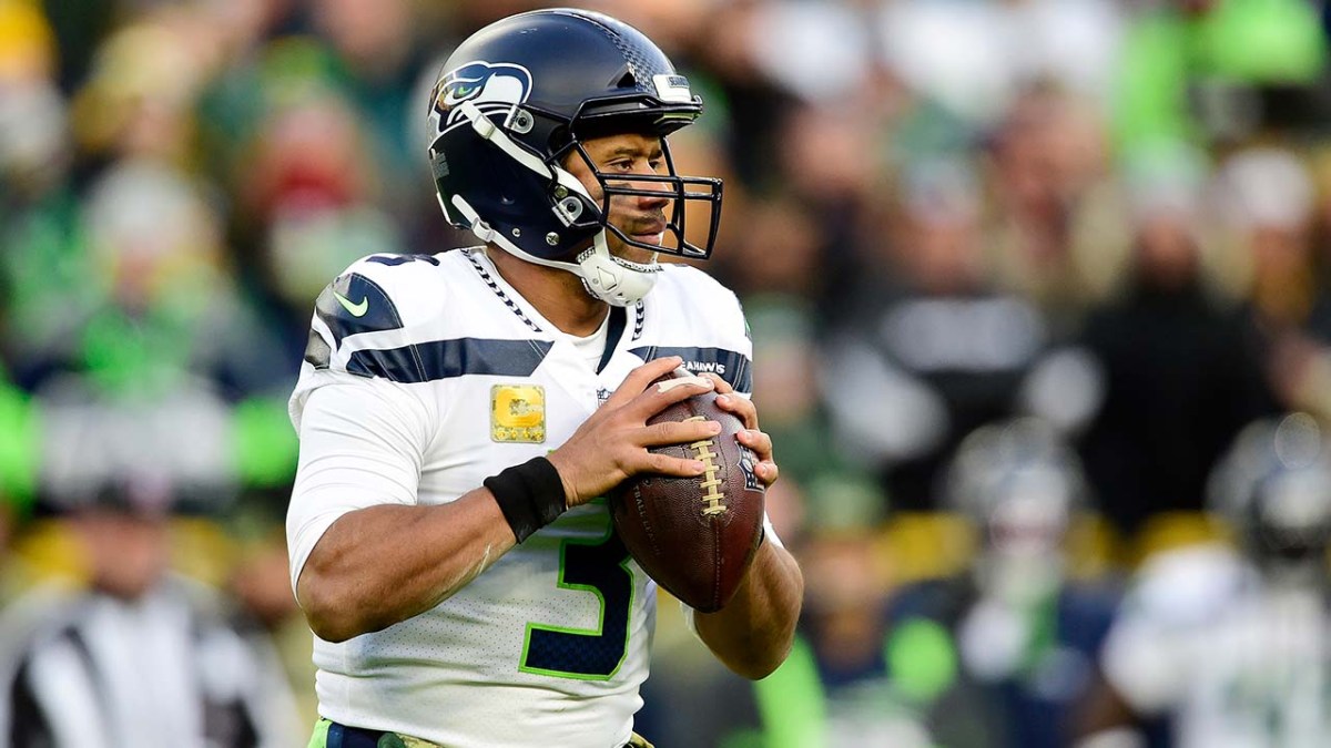 Russell Wilson, in Seahawks uniform, dropping back to pass